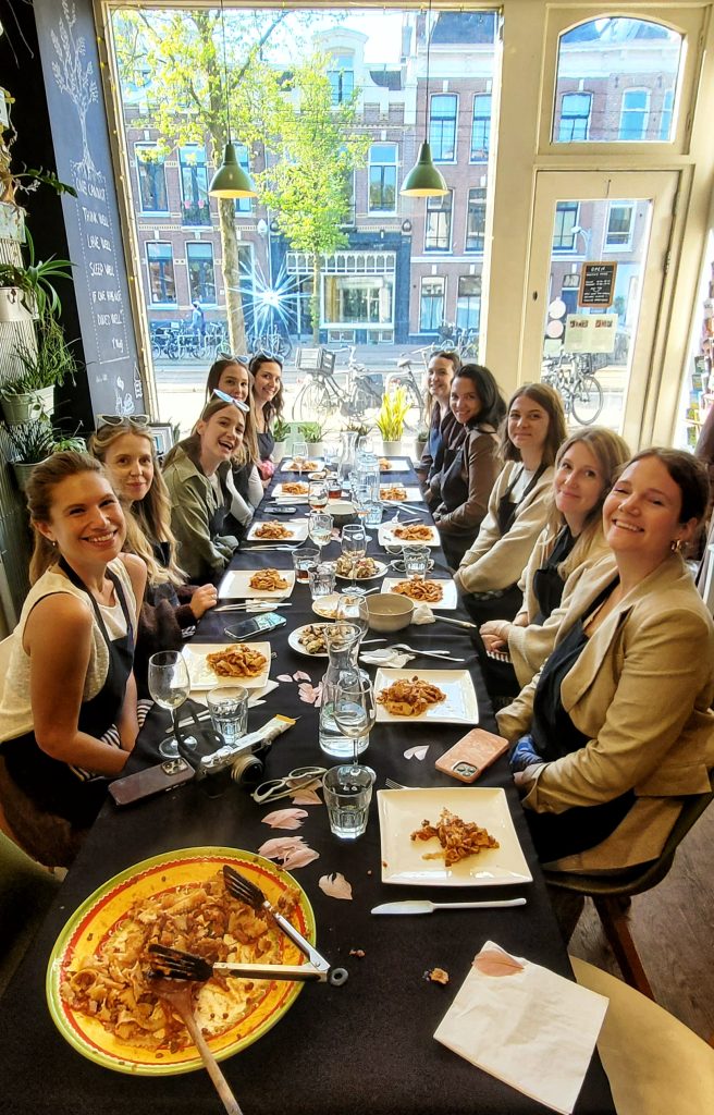 Participants enjoying their handmade pasta at private cooking workshop in Amsterdam
