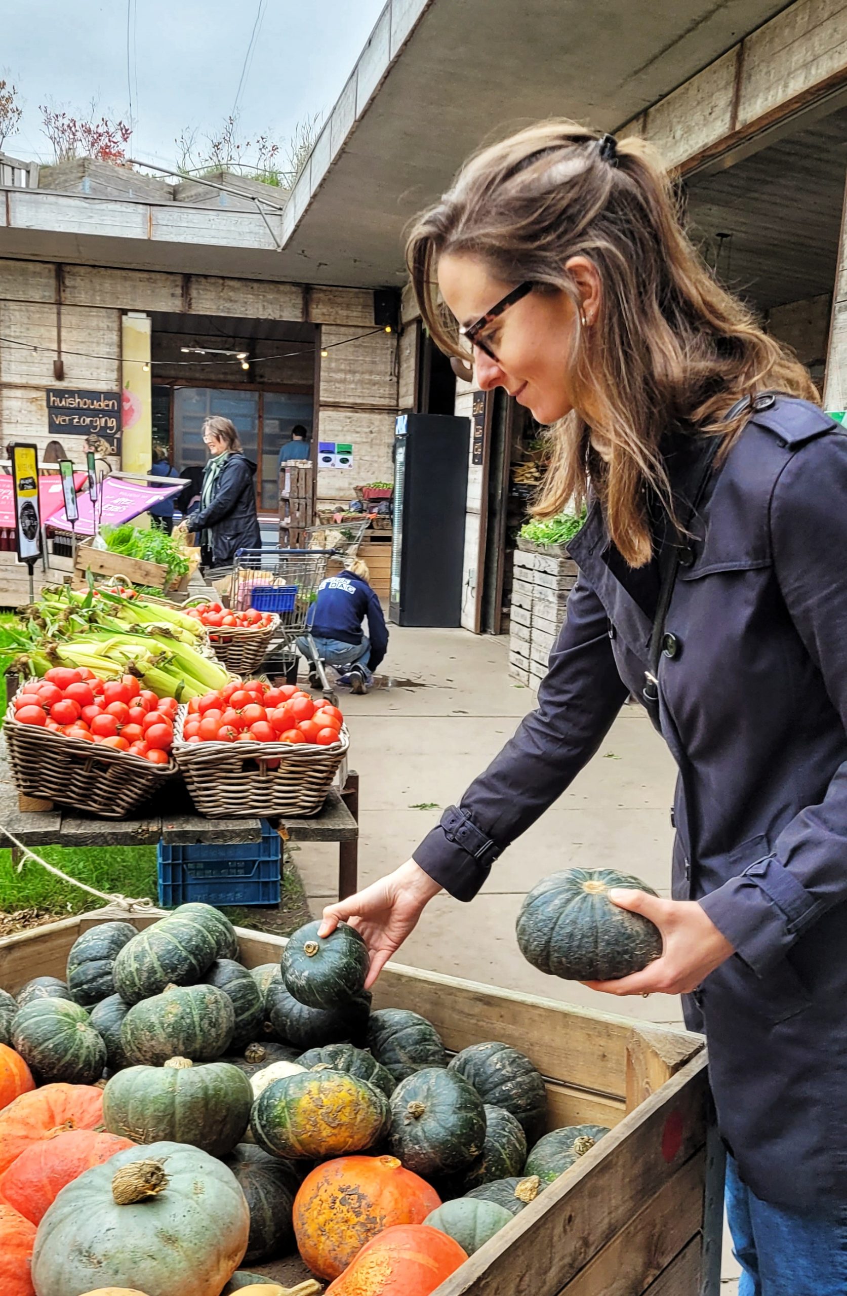 Micaela selecting fresh pumpkins at Fruittuin van West urban farm in Amsterdam